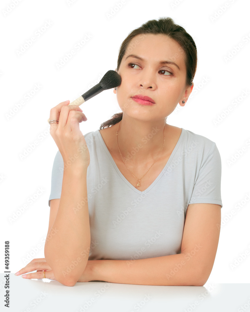 Isolated middle age asian woman with make up brush. Isolated middle age asian woman with make up brush.