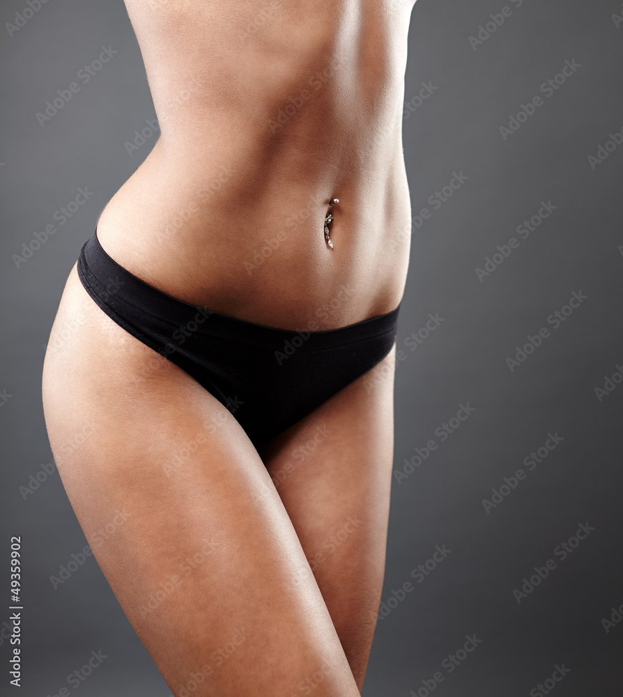 Fototapeta premium Perfect female body on gray background