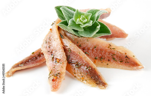 anchovies on white with spice and oregano