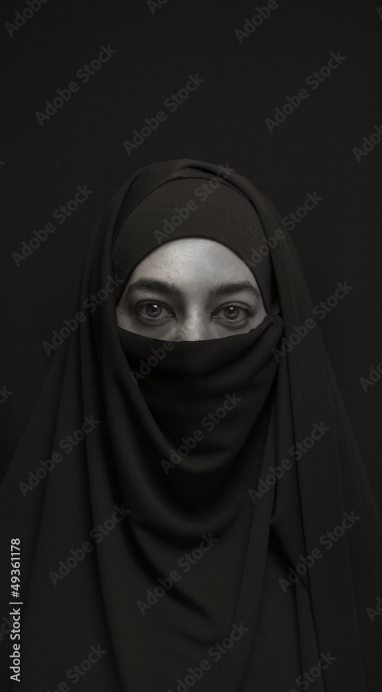 woman in burka over dark background