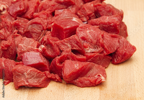 Fresh chopped beef steak on wood chopping board