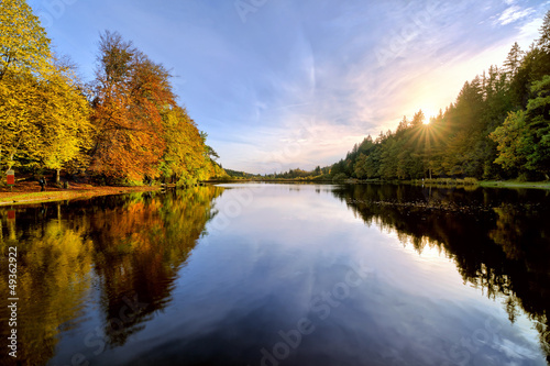 Fototapeta Naklejka Na Ścianę i Meble -  Sunset on Lake in Autumn Forest