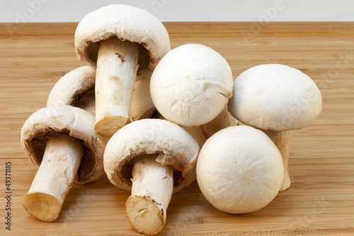 white champignons on a wooden board