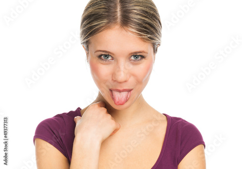 Cute woman pokes out her tongue