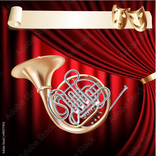 Classical French horn on a red velvet curtain background