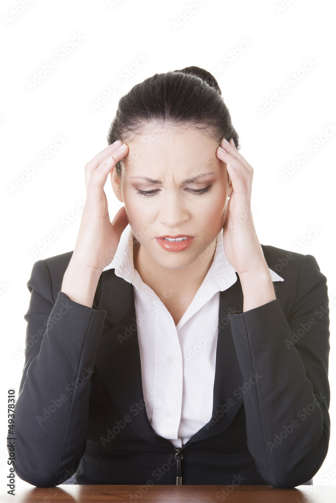 Sad businesswoman sitting behind the desk Sad businesswoman sitting behind the desk