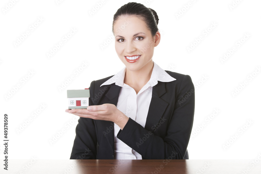Businesswoman with house model over white Businesswoman with house model over white