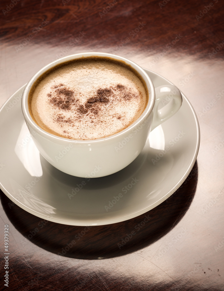 Cup of coffee on a wooden table in restaurant Cup of coffee on a wooden table in restaurant