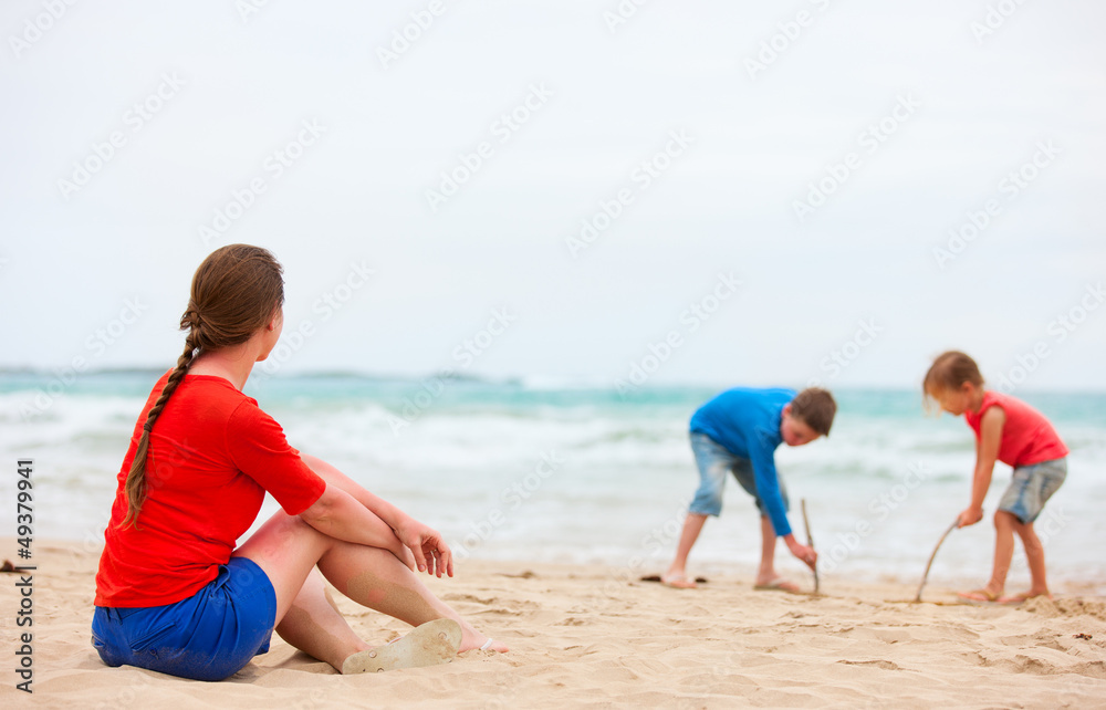 Mother and two kids at tropical beach Mother and two kids at tropical beach