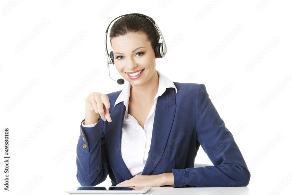 Beautiful young call-center assistant at the desk Beautiful young call-center assistant at the desk