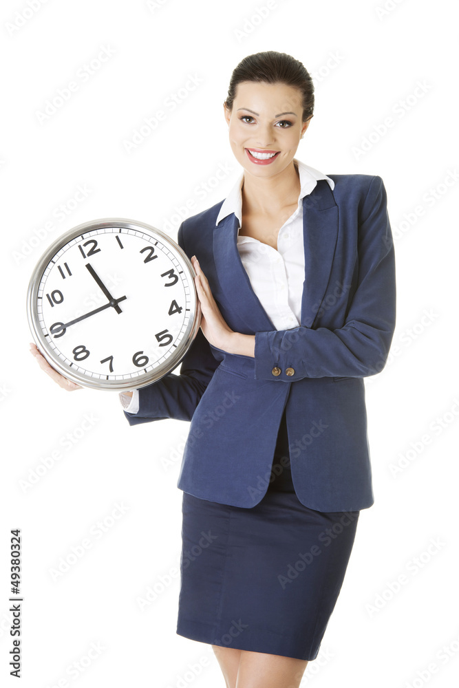 Happy young business woman holding office clock Happy young business woman holding office clock