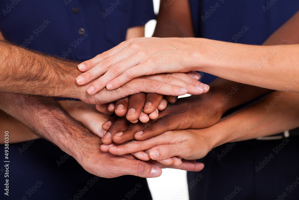 multiracial hands together to form teamwork multiracial hands together to form teamwork
