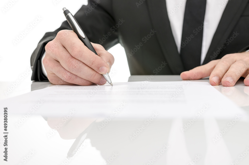 Front view of a business man signing a contract Front view of a business man signing a contract