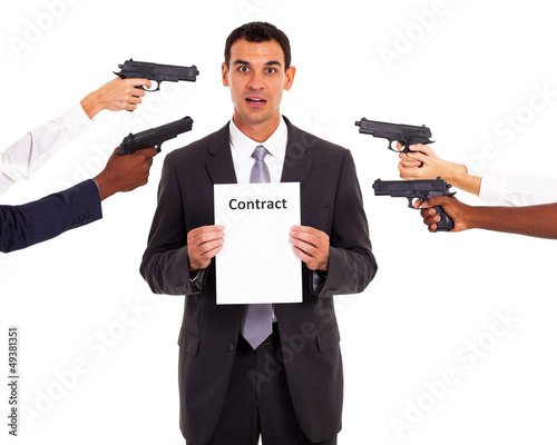 businessman holding forced contract at gun point