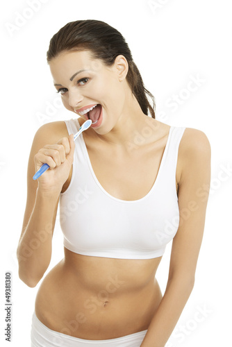 Happy pretty woman singing to tooth brush