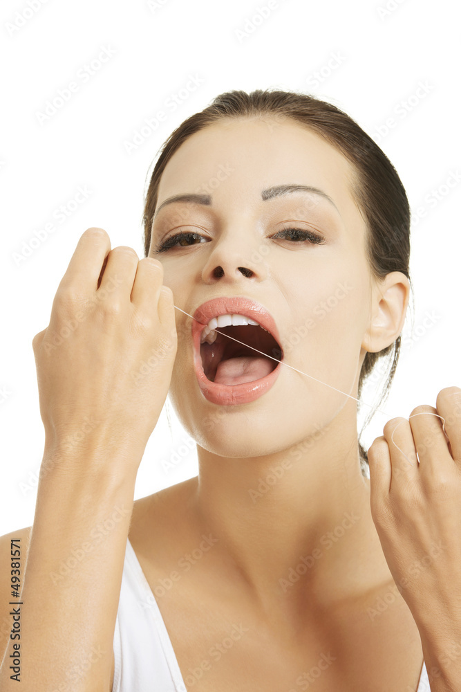 Beautiful young woman using dental floss Beautiful young woman using dental floss