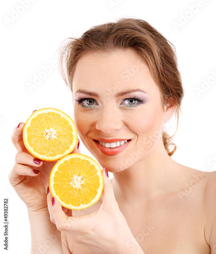 Beautiful young woman with bright make-up, holding orange,