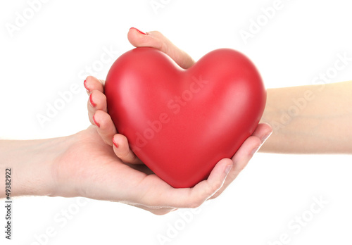 Red heart in woman and man hands  isolated on white