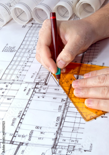Architect drawing rolls and plans blueprints project