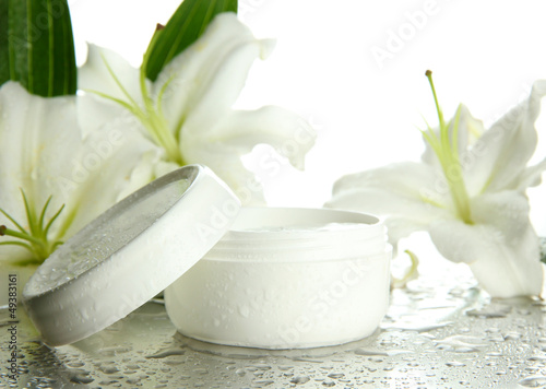 Fototapeta Naklejka Na Ścianę i Meble -  Cosmetic cream and beautiful lily, close up