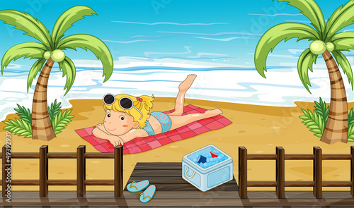A woman sunbathing at the beach
