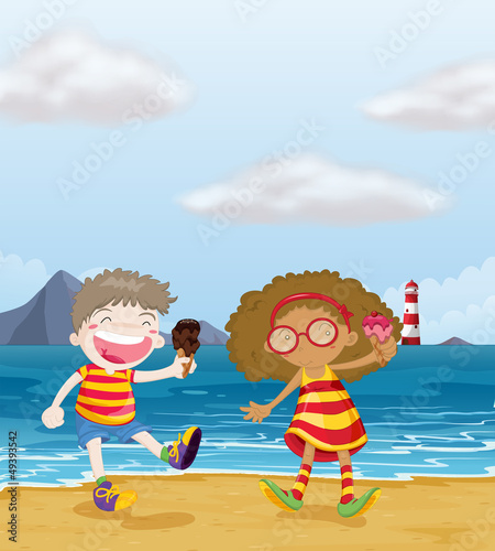 Happy kids with ice cream at the beach