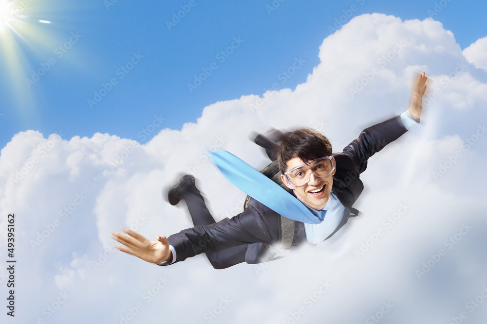 Young businessman flying with parachute on back Young businessman flying with parachute on back