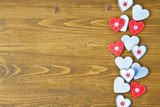 Wooden background with red hearts
