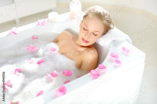 Attractive girl relaxing in bath