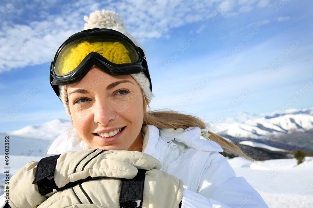 Portrait of cheerful blond woman at ski resort
