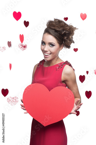 young cheerful woman holding red paper heart