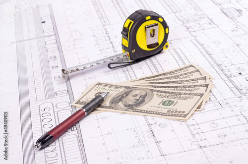 dollar banknotes on a construction plan