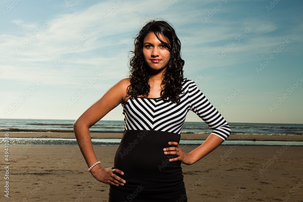 Pretty indian girl with long hair on the beach in summer. Pretty indian girl with long hair on the beach in summer.