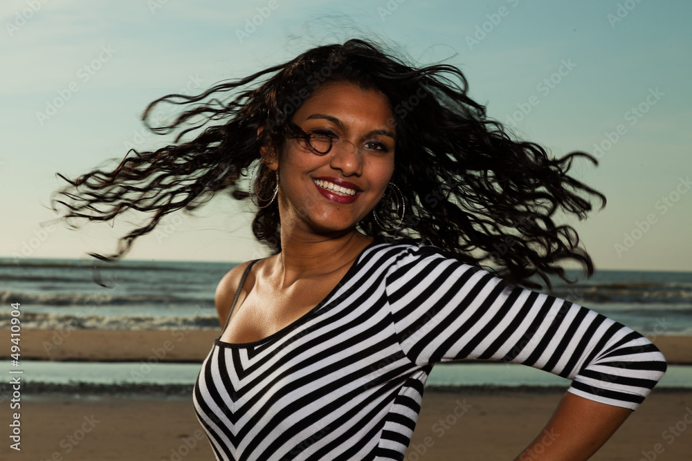 Pretty indian girl with long hair on the beach in summer. Pretty indian girl with long hair on the beach in summer.