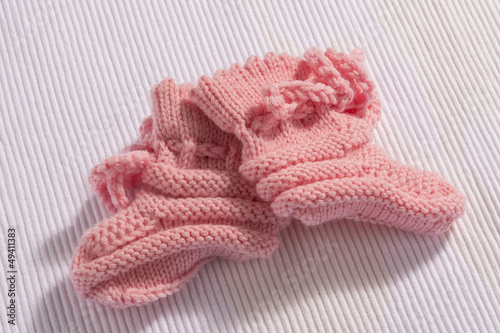 Pink baby socks on white background