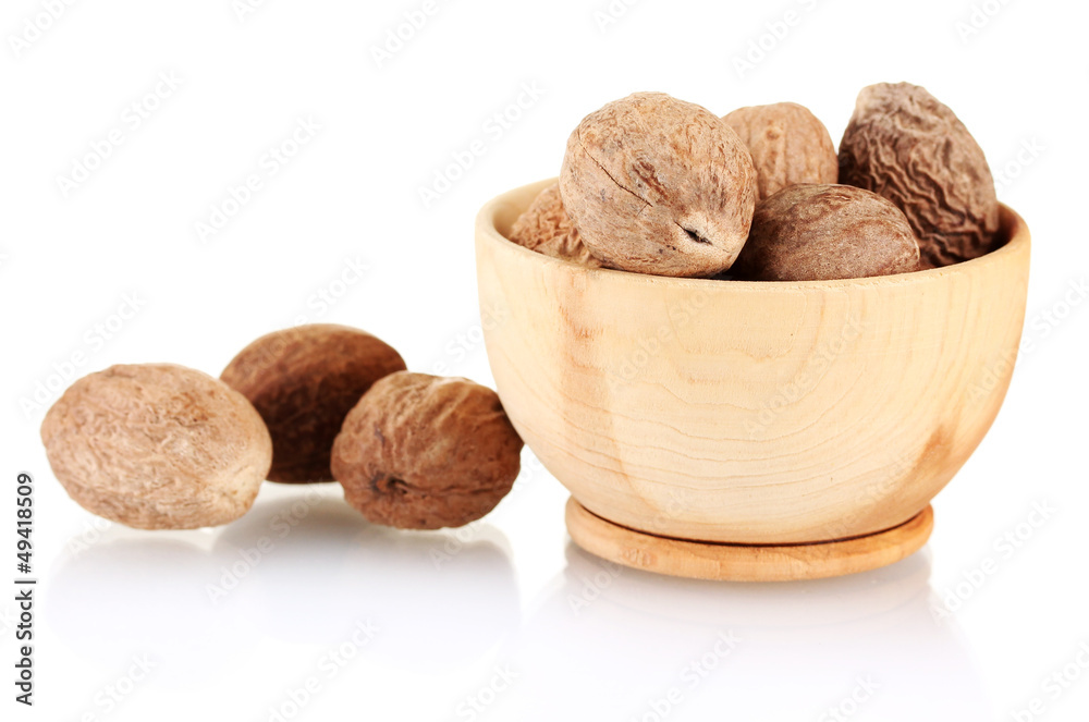 nutmeg in wooden mortar isolated on white nutmeg in wooden mortar isolated on white