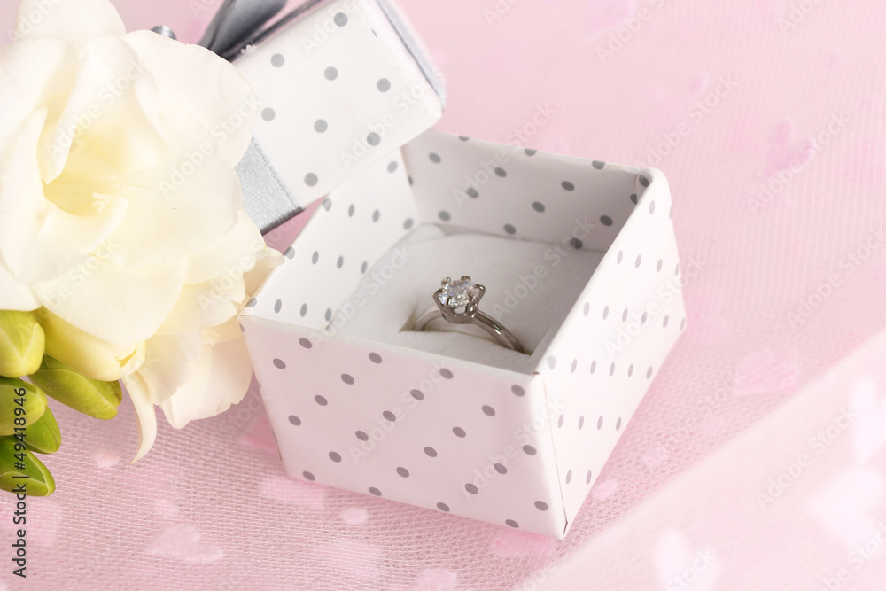Beautiful box with wedding ring and flower on pink background Beautiful box with wedding ring and flower on pink background