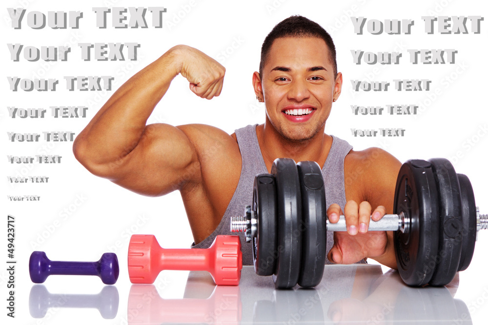 Attractive man posing in a studio with dumbbells Attractive man posing in a studio with dumbbells