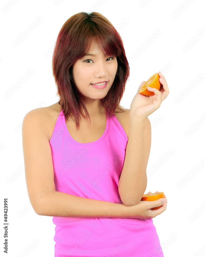 Isolated young asian woman with pieces of orange Isolated young asian woman with pieces of orange