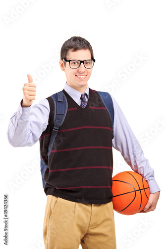 Male student with school bag holding a basketball and giving thu © Ljupco Smokovski