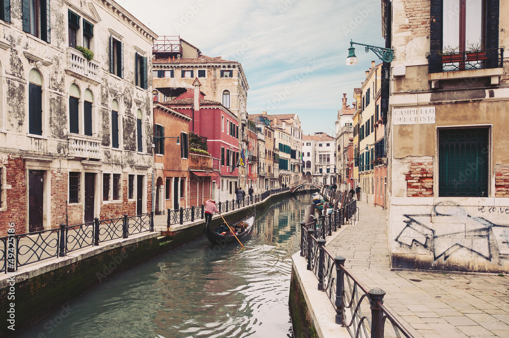 Typical canal with gondola. Venice, Italy.