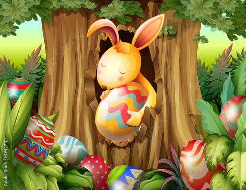 A rabbit inside the hole of a tree surrounded with eggs