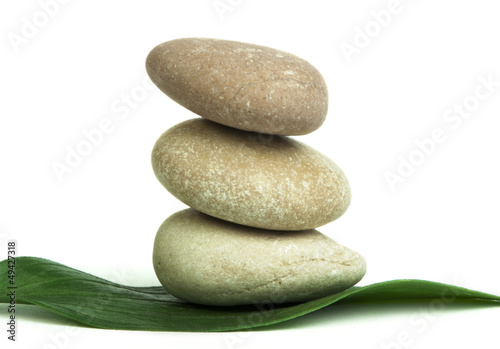 Stacked stones on base of green leafs