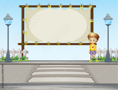 A boy near a blank ad space