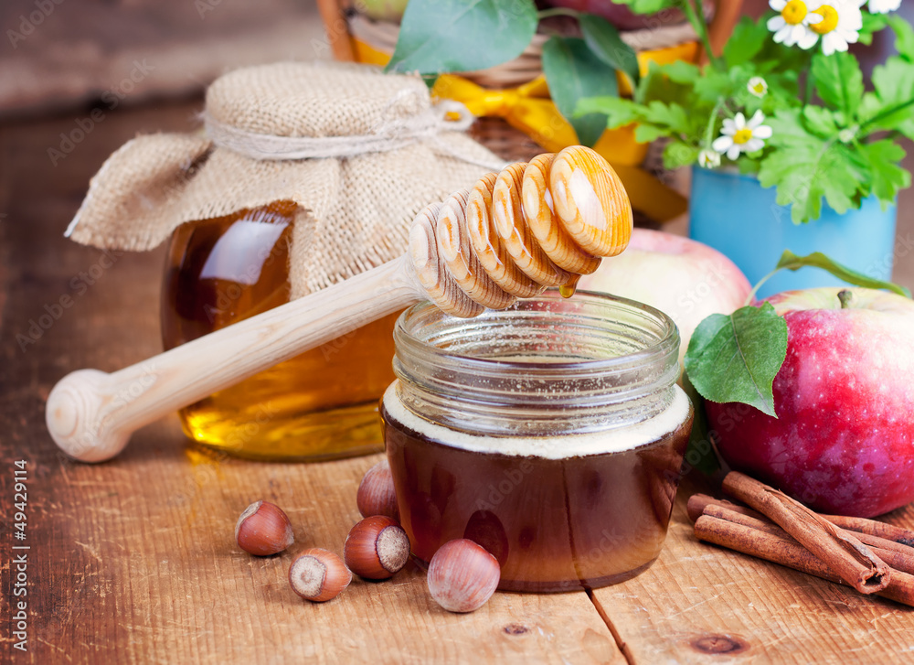 Honey in glass jars and honey stick Honey in glass jars and honey stick