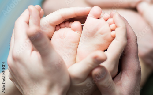 Parents  holding little newborns feets