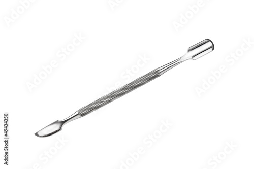 Metal manicure and pedicure cuticle pusher isolated on white photo