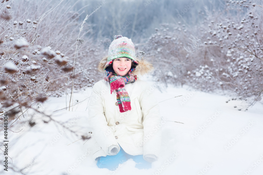 Happy smiling child playing in a snow field Happy smiling child playing in a snow field