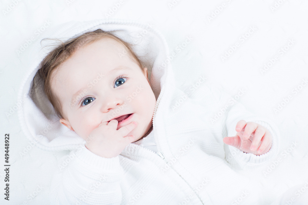 Adorable little baby sucking on its finger