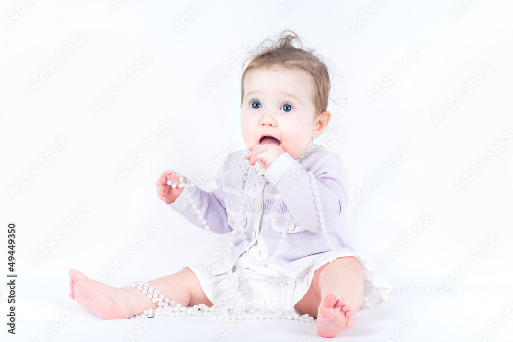 Elegant little girl with a pearl necklace